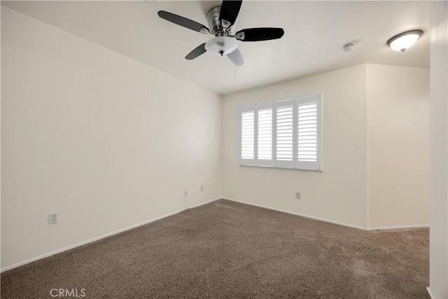 empty room featuring ceiling fan, carpet floors, and baseboards