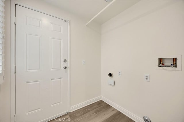 clothes washing area featuring hookup for a washing machine, electric dryer hookup, dark wood-style flooring, and baseboards