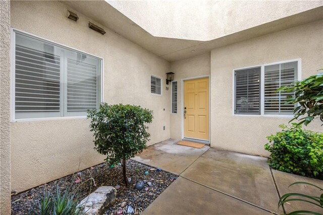 view of exterior entry with stucco siding