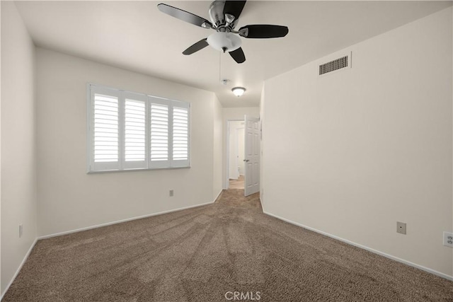 empty room featuring ceiling fan, carpet, and baseboards