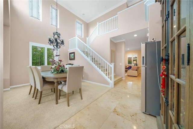5581 Tremaine Way, Chino Hills, CA 91709 - dining space featuring a high ceiling, crown molding, baseboards, stairs, and a chandelier