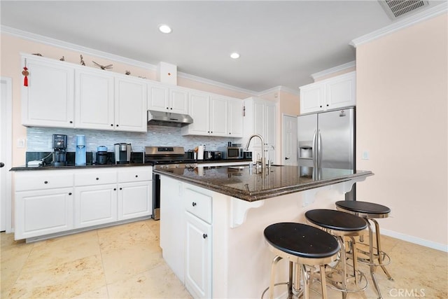 5581 Tremaine Way, Chino Hills, CA 91709 - kitchen featuring stainless steel appliances, under cabinet range hood, white cabinetry, backsplash, and an island with sink