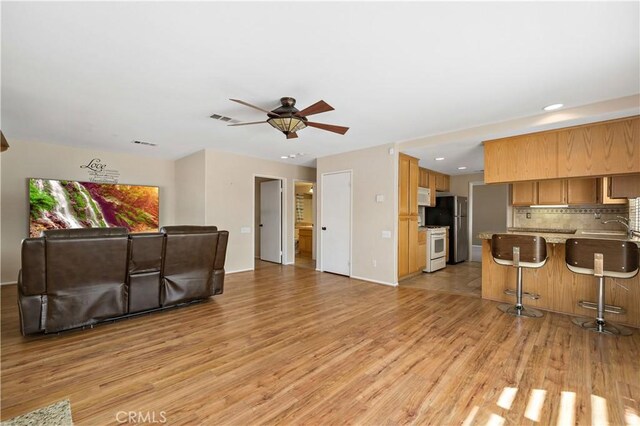1044 Jude Ct, San Jacinto, CA 92583 - living room featuring light wood-type flooring, ceiling fan, and recessed lighting