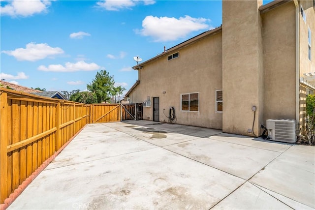 1044 Jude Ct, San Jacinto, CA 92583 - rear view of house with cooling unit, a gate, stucco siding, and a patio