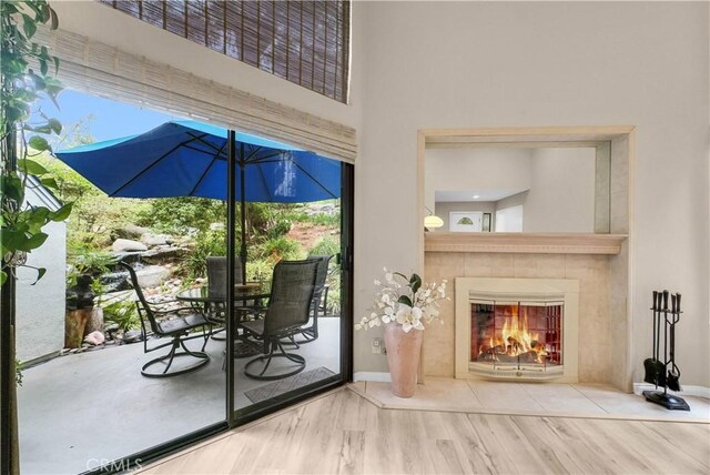 entryway with a fireplace, baseboards, and wood finished floors