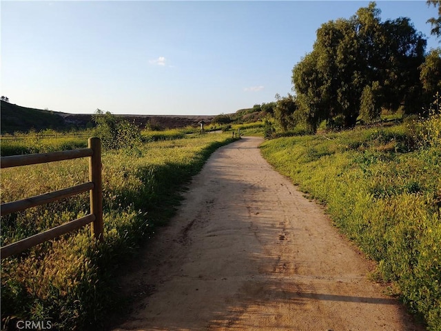view of dirt / gravel road with a view of rural / pastoral area