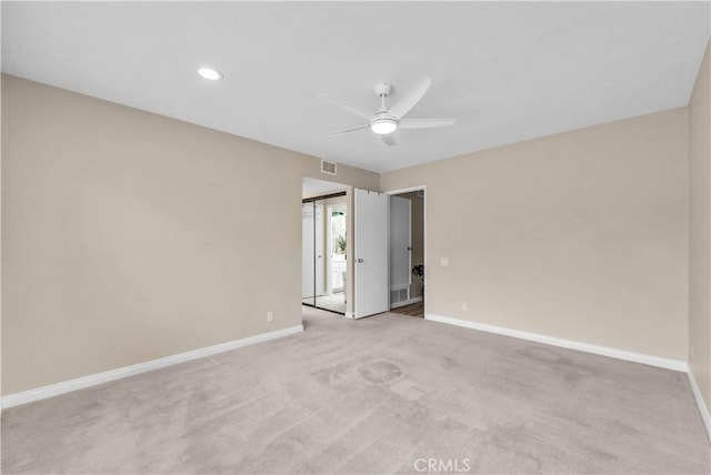 empty room with ceiling fan, baseboards, light carpet, and recessed lighting