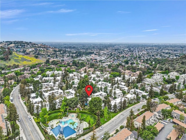 aerial overview of property's location with a pool area and nearby suburban area