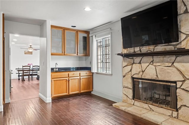5048 W 121st St, Hawthorne, CA 90250 - bar area featuring a sink, dark wood-style floors, a stone fireplace, baseboards, and recessed lighting
