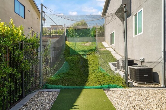view of yard with cooling unit and fence