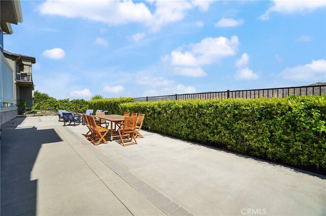 view of patio / terrace with outdoor dining area and fence