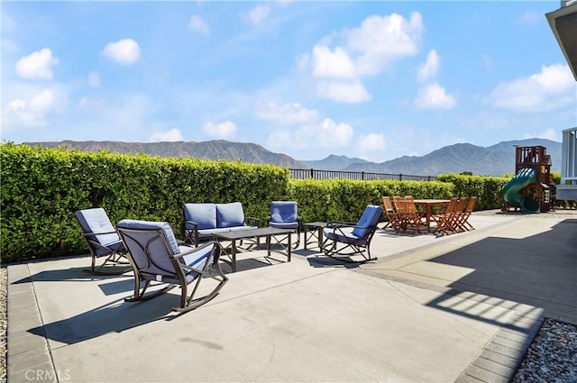 view of patio with a mountain view, fence, and an outdoor hangout area