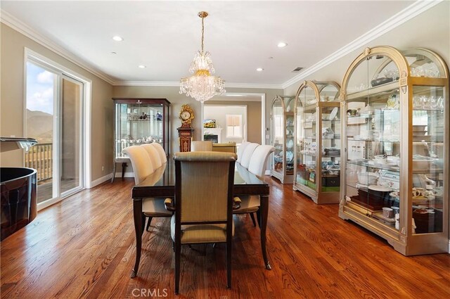 dining space with healthy amount of natural light, a chandelier, wood finished floors, recessed lighting, and crown molding