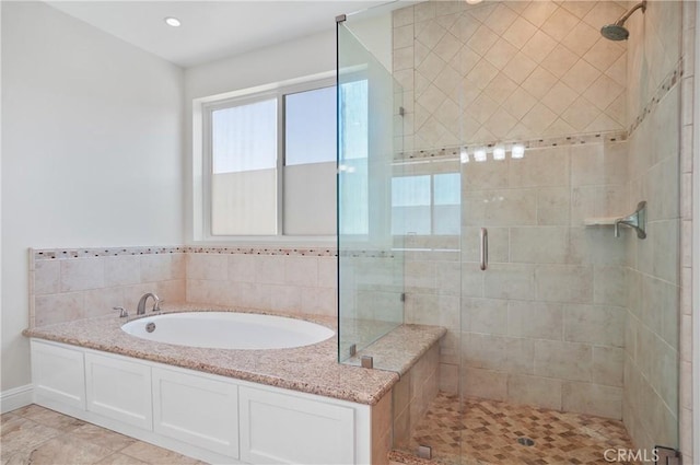 full bath featuring a shower stall and a garden tub