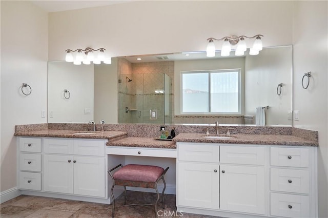 bathroom with a shower stall, vanity, and baseboards