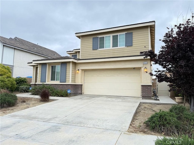 view of front of house featuring a garage, driveway, and brick siding