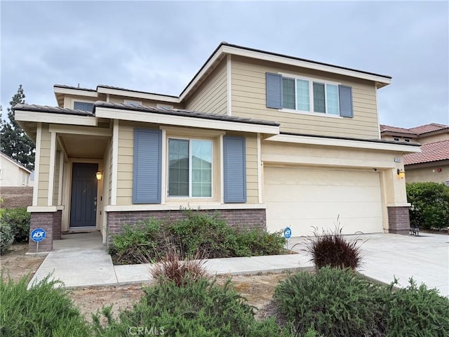 view of front of house with an attached garage, brick siding, and driveway