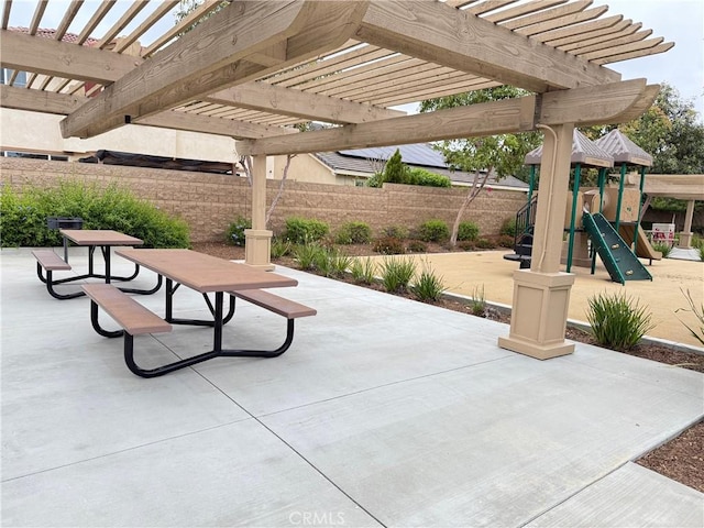 view of patio / terrace featuring a playground, a pergola, and fence