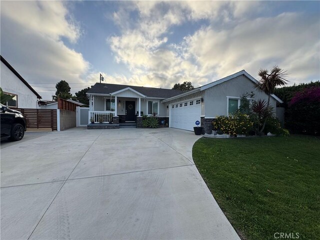 14825 Cranbrook Ave, Hawthorne, CA 90250 - single story home featuring a porch, an attached garage, concrete driveway, stucco siding, and stone siding