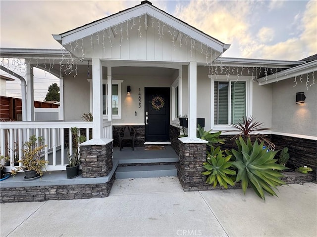 14825 Cranbrook Ave, Hawthorne, CA 90250 - entrance to property featuring covered porch, stucco siding, and stone siding