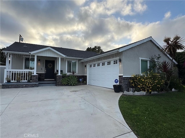 14825 Cranbrook Ave, Hawthorne, CA 90250 - view of front facade featuring stone siding, an attached garage, concrete driveway, covered porch, and stucco siding