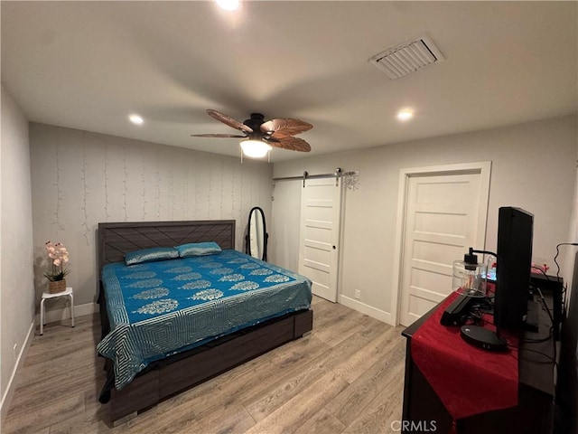 14825 Cranbrook Ave, Hawthorne, CA 90250 - bedroom with a barn door, light wood-style floors, baseboards, recessed lighting, and ceiling fan