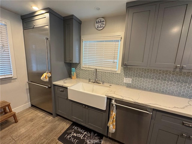 14825 Cranbrook Ave, Hawthorne, CA 90250 - kitchen with a sink, light wood finished floors, stainless steel appliances, backsplash, and gray cabinets