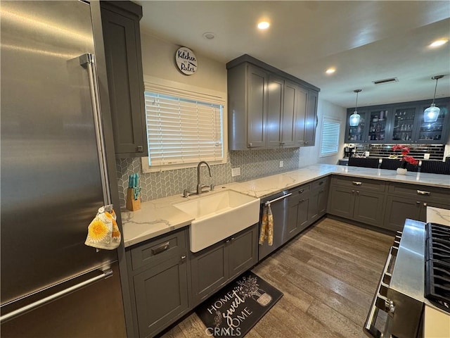 14825 Cranbrook Ave, Hawthorne, CA 90250 - kitchen with appliances with stainless steel finishes, a sink, gray cabinets, dark wood-type flooring, and backsplash