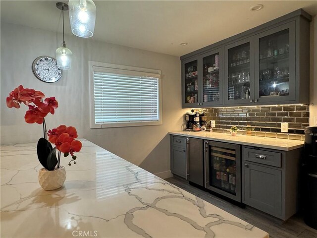 14825 Cranbrook Ave, Hawthorne, CA 90250 - indoor dry bar with beverage cooler, tasteful backsplash, pendant lighting, wood finished floors, and baseboards