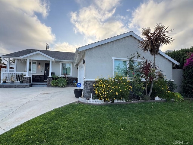 14825 Cranbrook Ave, Hawthorne, CA 90250 - view of front of house with covered porch, a front yard, and stucco siding