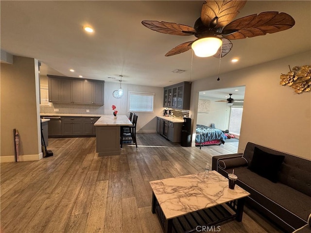 14825 Cranbrook Ave, Hawthorne, CA 90250 - living area with dark wood finished floors, ceiling fan, recessed lighting, plenty of natural light, and baseboards