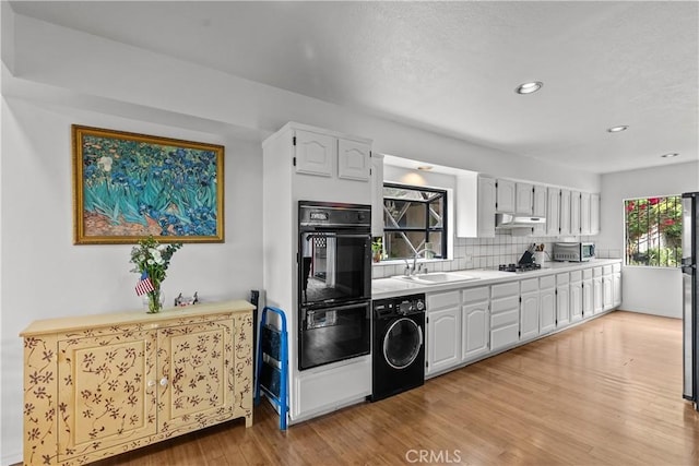 641 Sunnyhill Dr, Los Angeles, CA 90065 - kitchen with washer / dryer, a sink, decorative backsplash, white cabinets, and light countertops