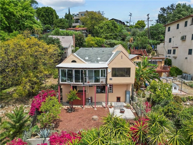641 Sunnyhill Dr, Los Angeles, CA 90065 - back of house featuring a sunroom, a patio area, and stucco siding