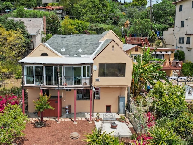 641 Sunnyhill Dr, Los Angeles, CA 90065 - back of property with stucco siding, a patio area, and a sunroom