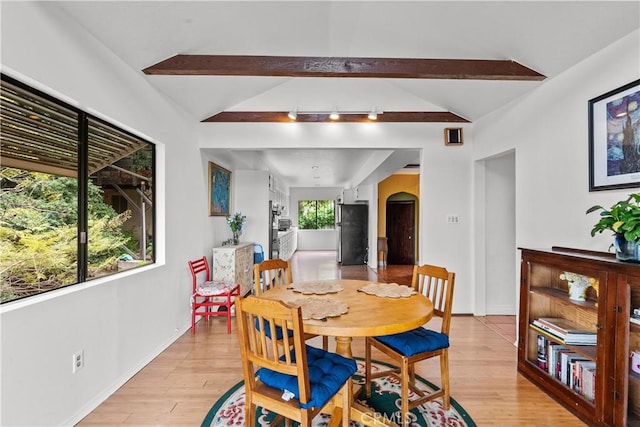 641 Sunnyhill Dr, Los Angeles, CA 90065 - dining room with arched walkways, light wood finished floors, and baseboards