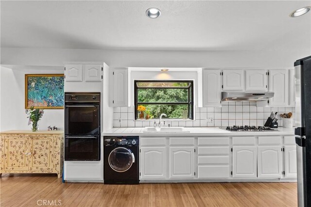 641 Sunnyhill Dr, Los Angeles, CA 90065 - kitchen with washer / dryer, a sink, stainless steel appliances, under cabinet range hood, and light countertops