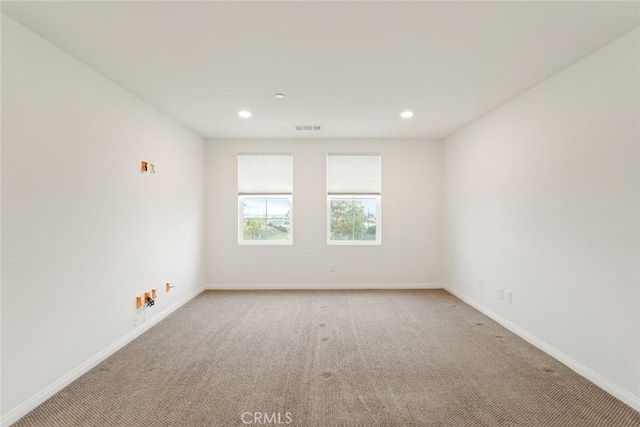 carpeted empty room with recessed lighting and baseboards
