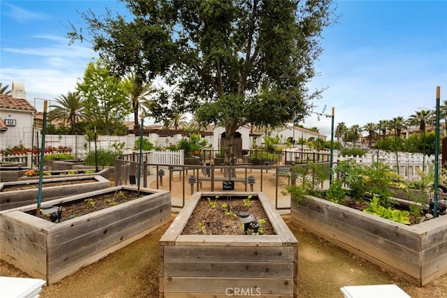 view of property's community featuring a vegetable garden and fence