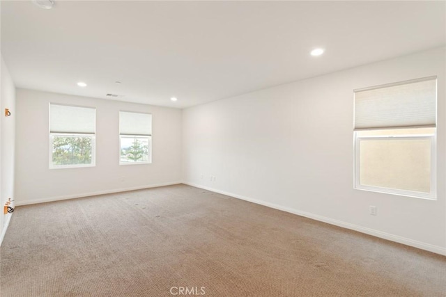 spare room with carpet flooring, recessed lighting, and baseboards