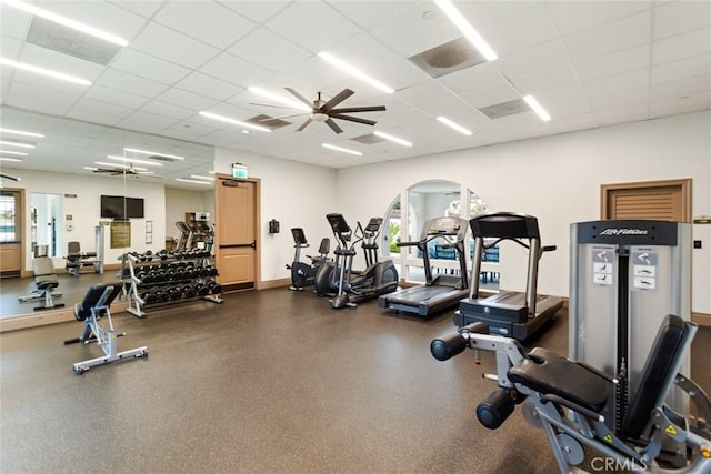 exercise room featuring ceiling fan and a paneled ceiling