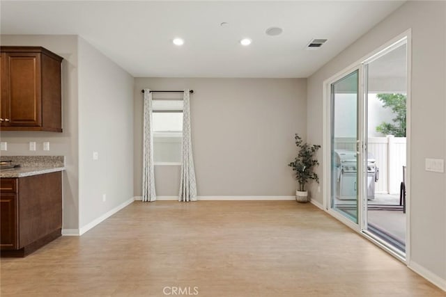 unfurnished dining area featuring light wood-style floors, recessed lighting, and baseboards