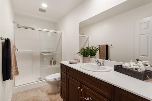 full bathroom with a stall shower, toilet, and vanity