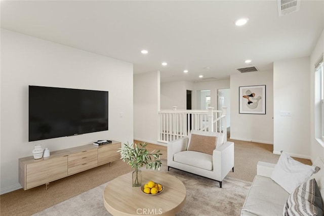 living room with light carpet, recessed lighting, baseboards, and healthy amount of natural light