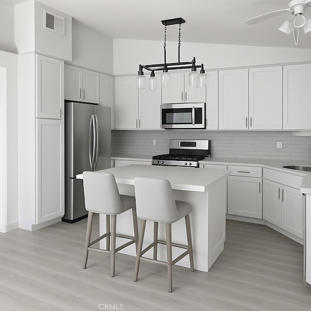 5314 Carlo Ct, Palmdale, CA 93552 - kitchen with appliances with stainless steel finishes, light wood-style flooring, light countertops, and a kitchen island
