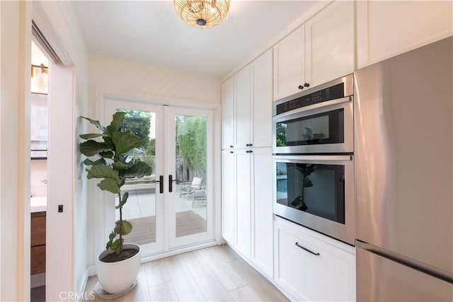 kitchen with stainless steel appliances, french doors, and white cabinets