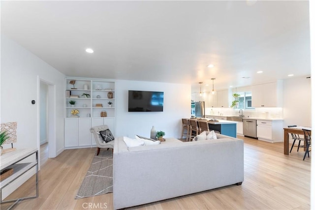 living room featuring light wood finished floors and recessed lighting