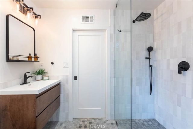 full bathroom with a walk in shower and vanity