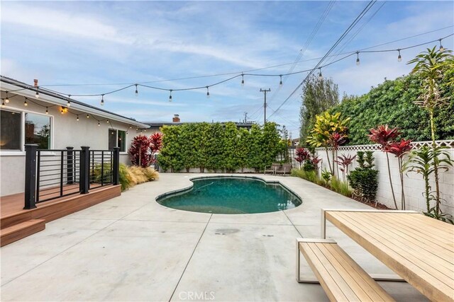 view of swimming pool featuring a patio and a fenced backyard