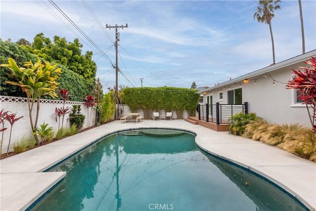 view of swimming pool featuring a fenced backyard and a patio area