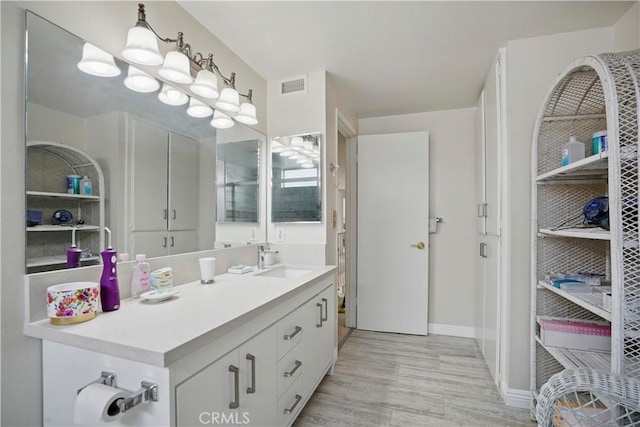 11806 Thunderbird Ave, Porter Ranch, CA 91326 - full bathroom with vanity, baseboards, and wood finished floors